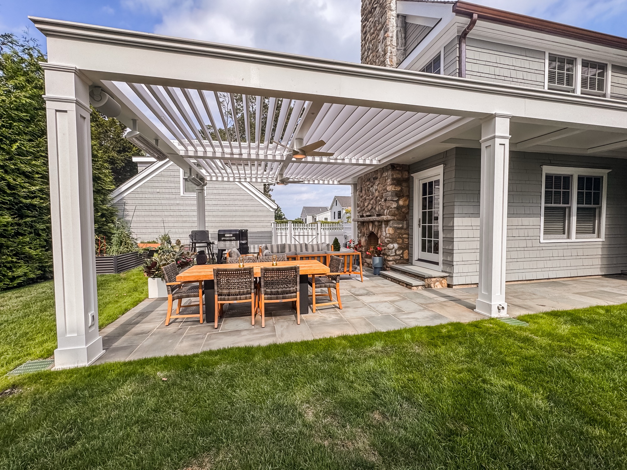 Transitional style pergola on gray shingle home